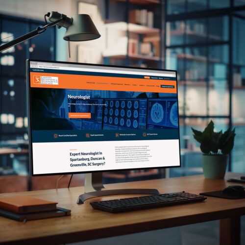 Carolina Orthopaedic and Neurosurgical Associates website open on a desktop monitor
